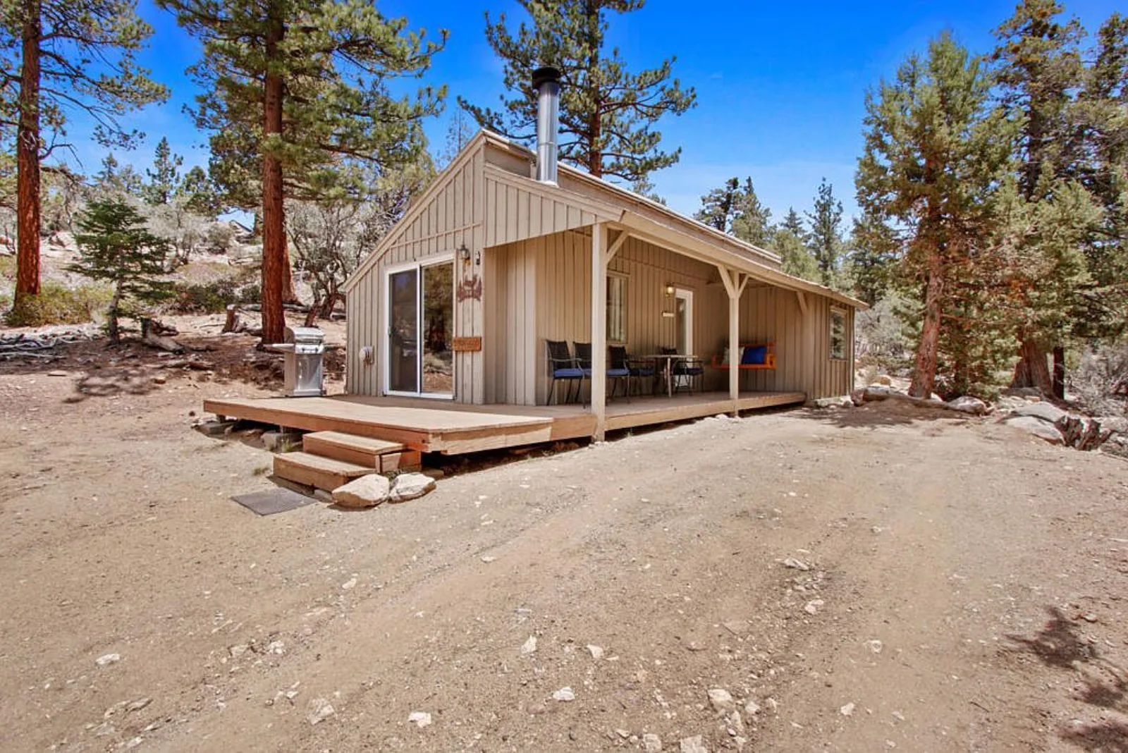 Ironwood cabin: board and batten siding, covered porch and deck among the pines